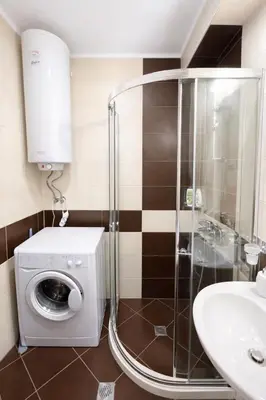 a bathroom with a washing machine and a sink at Harmony Suites 2 Private Studio 409 in Sunny Beach