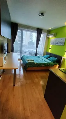 a bedroom with a bed and a table in a room at Complex-Lesso in Ravda