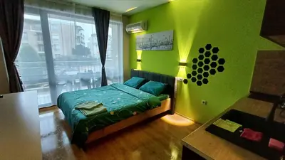 a green bedroom with a bed and a window at Complex-Lesso in Ravda
