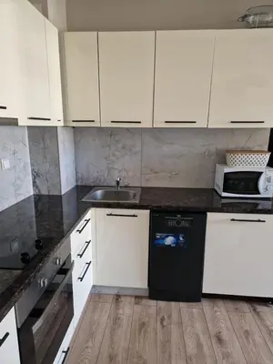 a kitchen with white cabinets and a sink at Garden of Eden- MintGarden- Sveti Vlas in Sveti Vlas