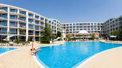 a large swimming pool with people in a resort at KJ Apartments - SwimmingPool - 3 Min From the Beach in Burgas City