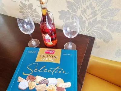 a book and two wine glasses on a table at ROYAL BEACH HOTEL apartment SEA B in Sunny Beach
