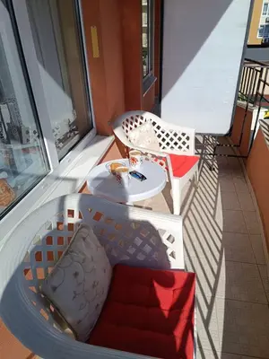 a balcony with two chairs and a table on a balcony at Aquamarin Studio B - Słoneczny Brzeg-Nesebyr in Sunny Beach