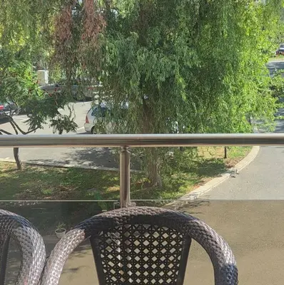 a rattan chair sitting on top of a balcony at Galqna in Sozopol