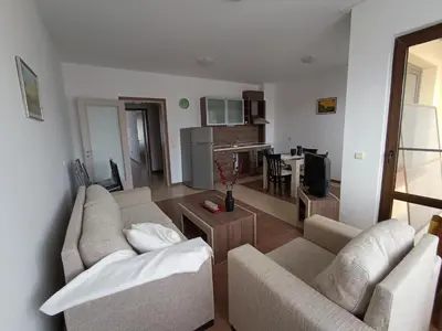 a living room with two couches and a kitchen at Апартаменти Литорал in Chernomorets