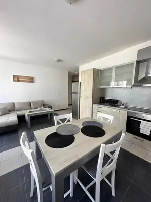 a kitchen and living room with a table and chairs at Апартаменти Литорал in Chernomorets