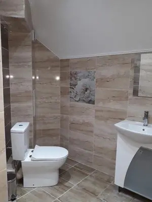 a bathroom with a toilet and a sink at South Beach Apartments in Obzor