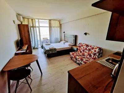a living room with a bed and a couch at Privately owned Studios Bora Bora in Nesebar