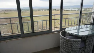 a balcony with a table and a view of a field at Privately owned Studios Bora Bora in Nesebar
