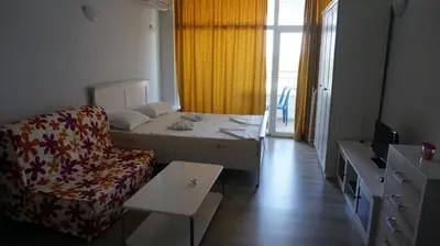 a small room with a bed and a chair at Privately owned Studios Bora Bora in Nesebar