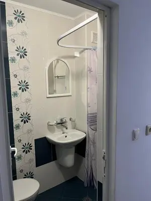 a white bathroom with a sink and a mirror at kaLe in Ravda