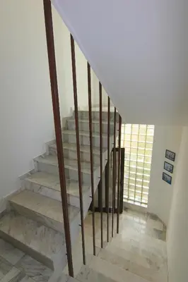 a staircase with wooden railings in a house at kaLe in Ravda