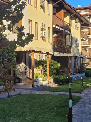 a building with a bird cage in the courtyard at Garden of Eden- MintGarden- Sveti Vlas 1 in Sveti Vlas
