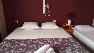 a bedroom with two beds with white pillows at Панорама in Pomorie