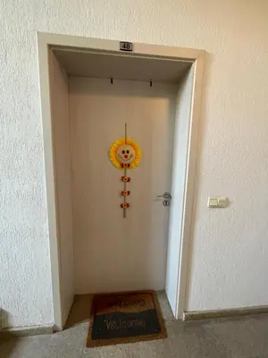 a hallway with a door with a smiley face decoration at Flat on the beach in Chernomorets