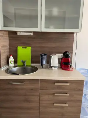 a kitchen counter with a sink and a microwave at Flat on the beach in Chernomorets