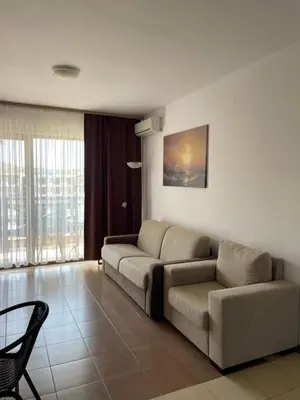 a living room with a couch and a chair at Flat on the beach in Chernomorets