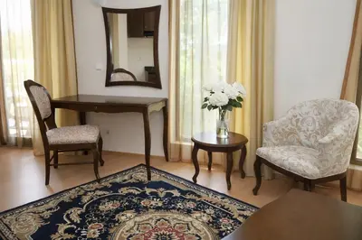 a living room with a table and chairs and a mirror at Luxury Studio in Sunny Beach with Pool, 5 Mins Walk to Beach in Sunny Beach