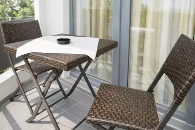 a table and two chairs on a balcony at Luxury Studio in Sunny Beach with Pool, 5 Mins Walk to Beach in Sunny Beach