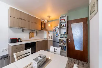 a kitchen with a white table and a dining room at Bright City-Center Flat for 4 Guests in Varna City