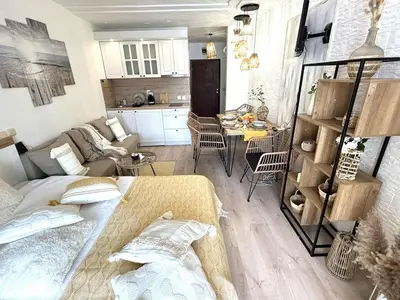 a small living room with a couch and a kitchen at Green Life Boho Apartment in Sozopol