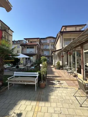 a patio with a white bench and some buildings at Family house ''Siema'' in Nesebar