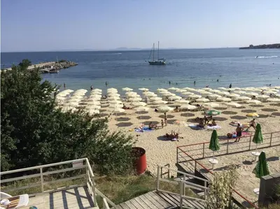 a beach with umbrellas and people on the beach at Family house ''Siema'' in Nesebar