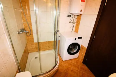 a bathroom with a washing machine and a washer at Sunset Beach 3 - Menada Apartments in Sunny Beach