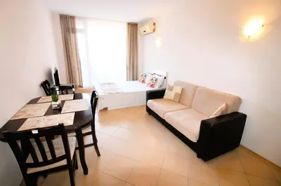 a living room with a couch and a table at Sunset Beach 3 - Menada Apartments in Sunny Beach