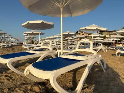a group of chairs and umbrellas on a beach at Soleil Bleu in Nesebar