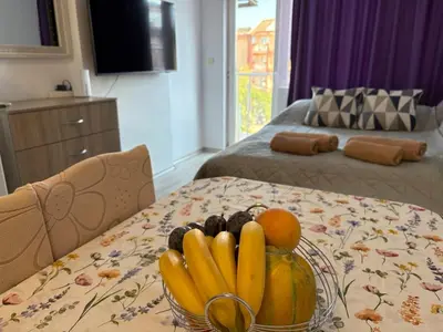 a bowl of fruit on a table in a bedroom at Soleil Bleu in Nesebar