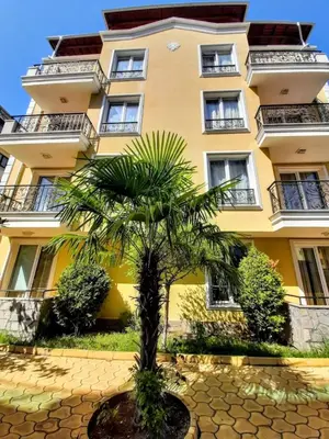 a palm tree in front of a building at Magnolia 3 - Menada Apartments in Sunny Beach