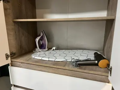 a cupboard with a blow dryer in it with a drawer at Varna Central Seaside Suite in Varna City