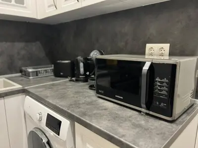 a microwave sitting on a counter in a kitchen at NJ Collection in Varna City