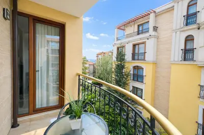 a balcony with a table and a view of buildings at Harmony Suites-2 Private Apartment 404 in Sunny Beach