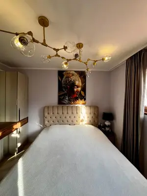 a bedroom with a bed with a painting on the wall at Golden Nest B25 in Nesebar