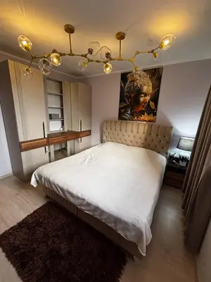 a bedroom with a bed with a headboard and lights at Golden Nest B25 in Nesebar