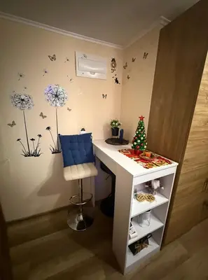 a room with a desk and a christmas tree on the wall at Студио-Джени in Burgas City
