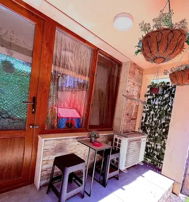 a room with a table and chairs and a window at Студио-Джени in Burgas City