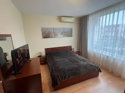 a bedroom with a bed and a large window at Nessebar Fort Club in Sunny Beach