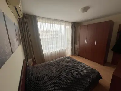 a bedroom with a bed and a large window at Nessebar Fort Club in Sunny Beach