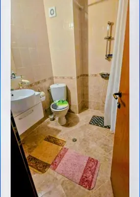 a bathroom with a toilet and a sink and a shower at Sunny Day 3 Sky Garden Maisonette Sun Terraces in Sunny Beach