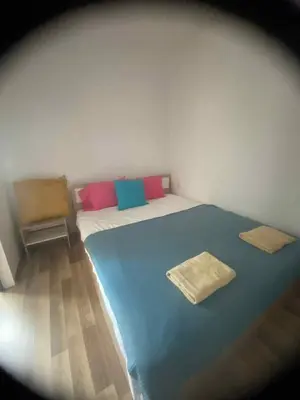 a bedroom with a blue and white bed and a chair at Amadues Lux, 1 Bed - Central to Sunny Beach in Sunny Beach