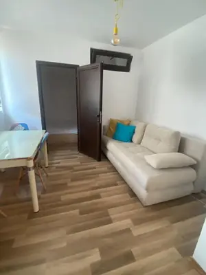 a living room with a white couch and a table at Amadues Lux, 1 Bed - Central to Sunny Beach in Sunny Beach
