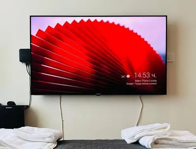 a flat screen tv hanging on a wall at Слънчев Бряг Какао с басейн плаж in Sunny Beach