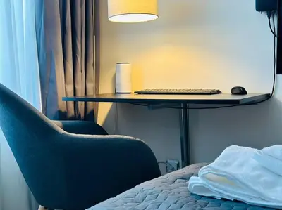 a room with a bed and a desk with a computer keyboard at Слънчев Бряг Какао с басейн плаж in Sunny Beach