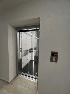an elevator door in a building with a window at Izgrev View apartment bs in Burgas City