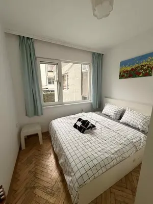 a bedroom with a bed and a window at Dimitrov cathedral apartament in Varna City