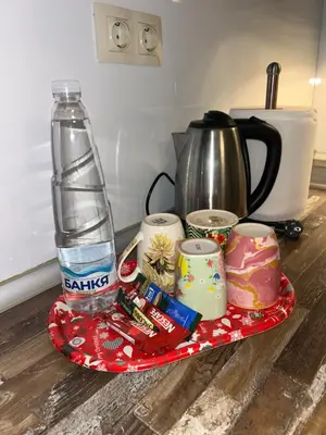 a plate with a water bottle and a tea kettle at Dimitrov cathedral apartament in Varna City