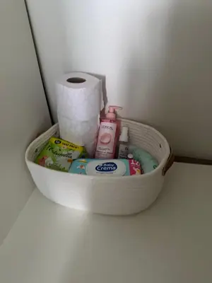 a basket with toiletries and a roll of toilet paper at Dimitrov cathedral apartament in Varna City